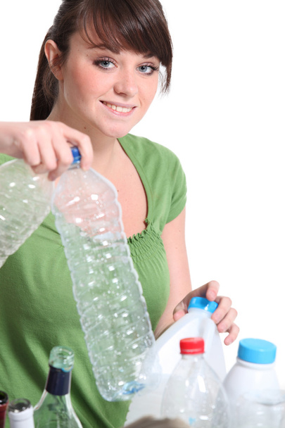 Teenage girl sorting the recycling - Фото, зображення
