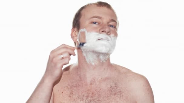 Adult man shaving with foam and manual razer. Slow motion - Filmati, video