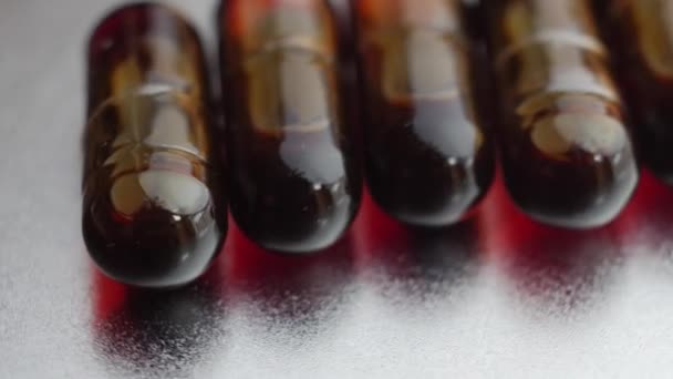 Medicijnen en Drugs. Olie pillen zilveren achtergrond inschakelen. - Video