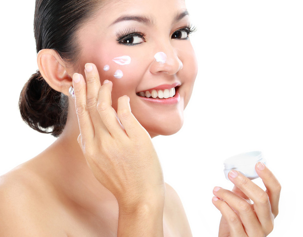 Woman applying moisturizer cream - Фото, зображення