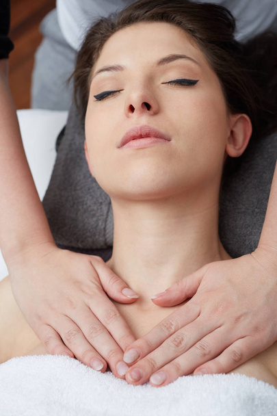  Relaxing beautiful woman having a massage for her skin on a face in beauty salon  - Fotó, kép