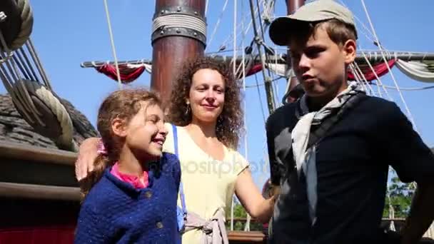 Woman with children poses on pirate ship - Filmati, video