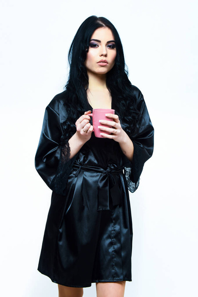 sexy girl posing in black silk robe with cup - 写真・画像