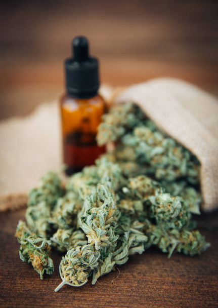  Medicinal cannabis with extracted oil in a bottle - 写真・画像