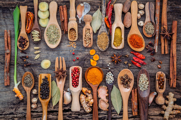 Various of spices and herbs in wooden spoons. Flat lay of spices - Photo, Image
