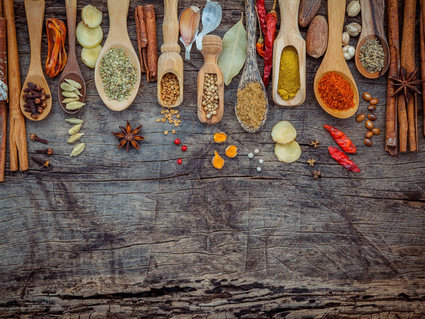 Various of spices and herbs in wooden spoons. Flat lay of spices - Фото, зображення