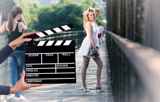 Clapperboard sign hold by female hands. - Photo, Image
