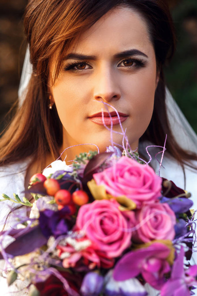 Pretty bride with violet bouquet  - Фото, зображення