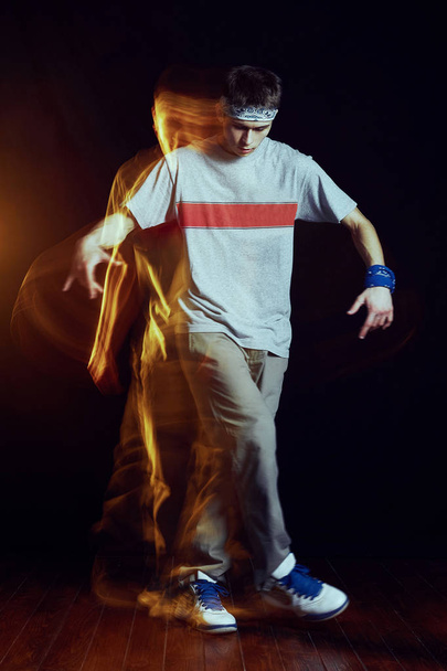 Man break dancing on wall background - Foto, afbeelding