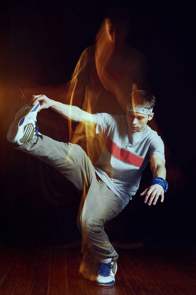 Man break dancing on wall background - Фото, изображение
