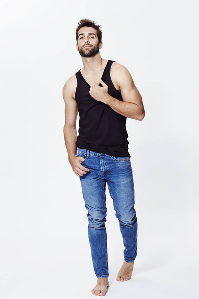 Guy posing in vest and jeans - Фото, изображение