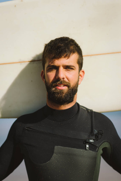 Bearded male surfer portrait holding his surfboad - Фото, изображение