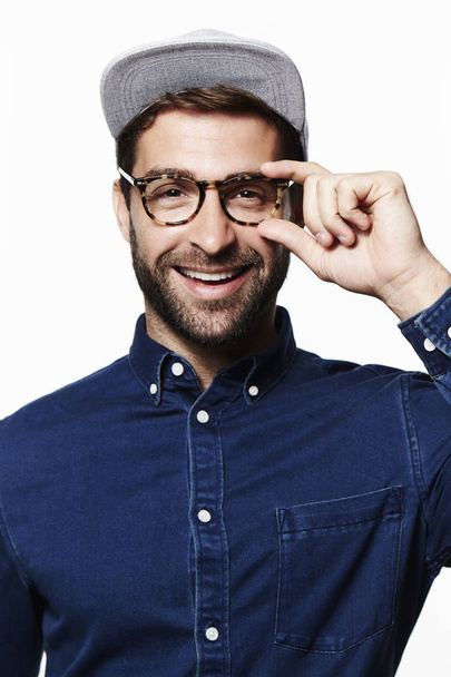 Smiling man in glasses and cap - Фото, изображение