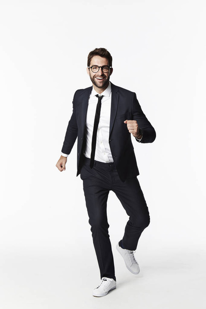 Running businessman in eyeglasses  - Fotografie, Obrázek