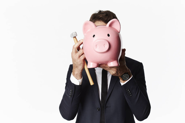 Businessman covering face with piggybank - Foto, imagen