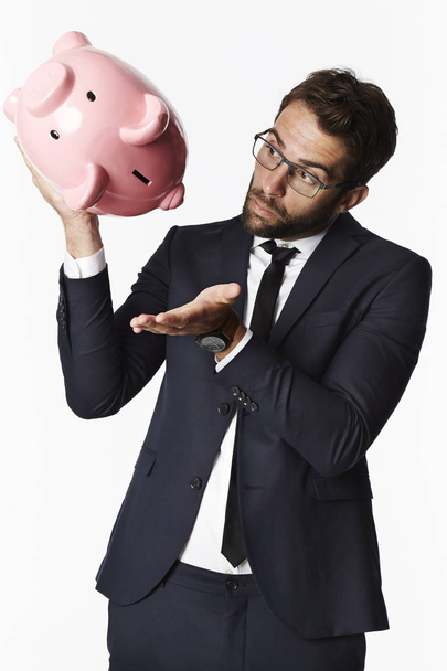Businessman shaking empty piggybank - Foto, Imagen