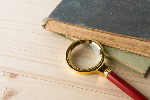 Magnifying glass and book - Фото, изображение