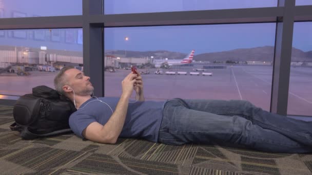 Man rest on floor after flight cancellation - Footage, Video