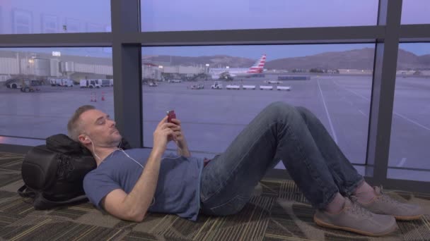 Stranded traveler laying on floor - Footage, Video
