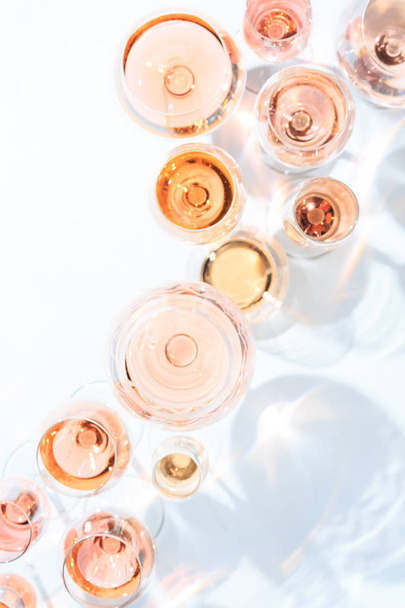 Many glasses of rose wine at wine tasting. Concept of rose wine  - Фото, изображение