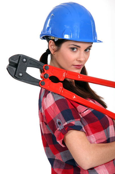 Female construction worker holding a pair of heavy-duty clippers - Zdjęcie, obraz