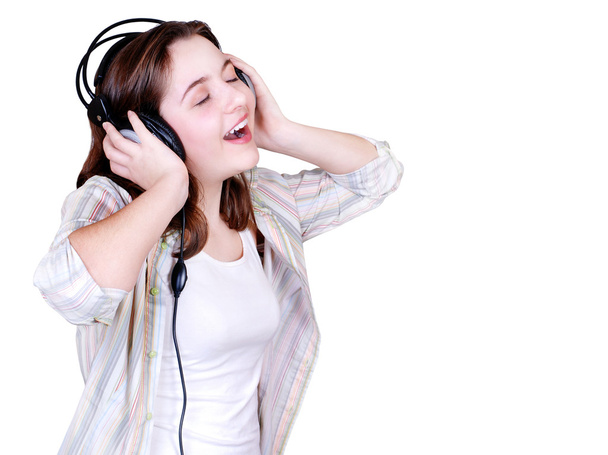 Portrait of singing teenage girl in headphones - 写真・画像