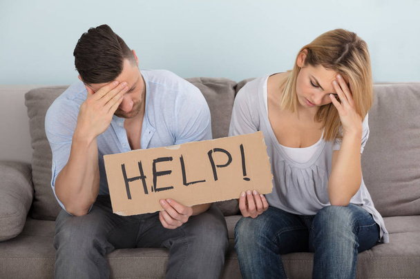 Worried Couple Holding Help Sign - Фото, зображення