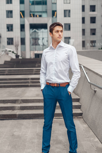 Businessman holds hands in his trouser pockets - Фото, зображення