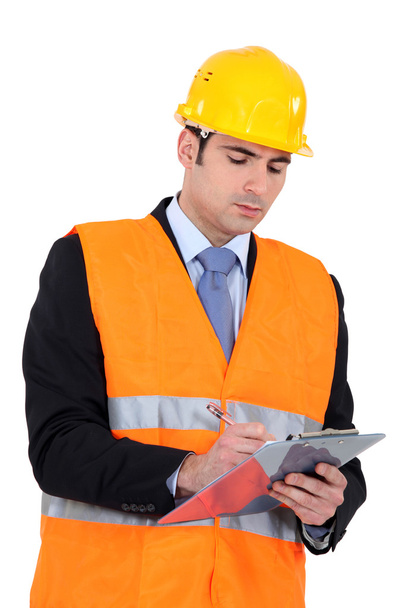 Businessman on a construction site taking notes - Φωτογραφία, εικόνα