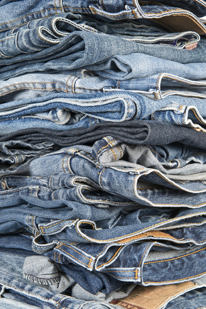 Stack of different old worn blue jeans - Foto, afbeelding