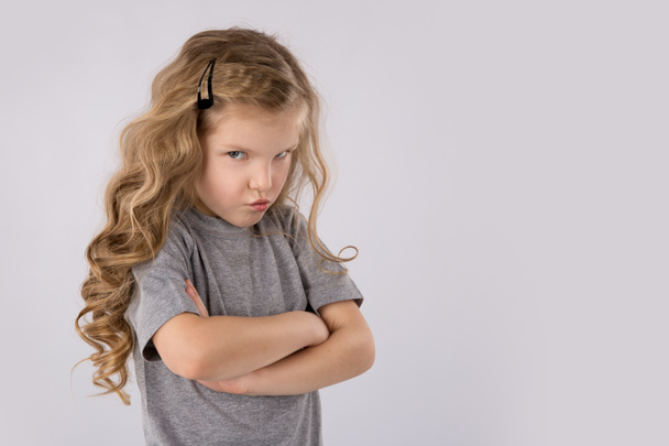 Portrait of angry and sad little girl isolated on white background - Photo, Image
