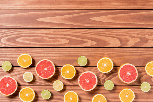 Sliced fruits on brown wooden table - Photo, Image