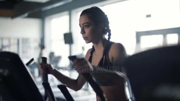 woman training on elliptical machine - Footage, Video