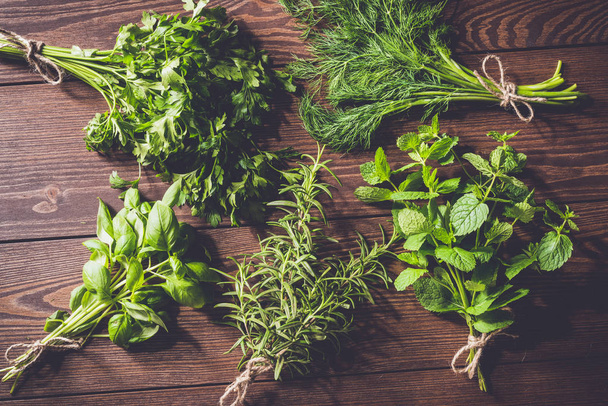 Fresh herbs on an old wooden table - Photo, image