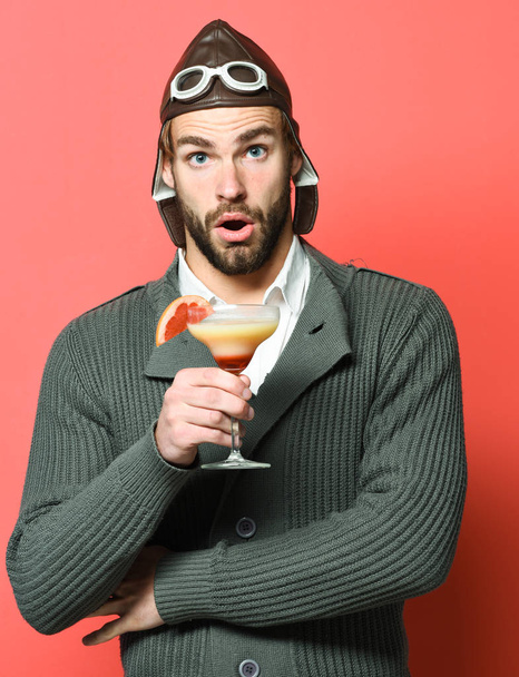 bearded pilot with cocktail in glass - Fotó, kép