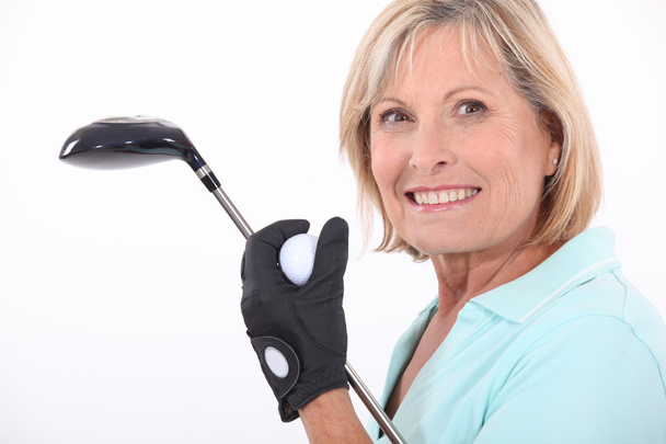 Mature blonde woman taking golf club and golf ball - Photo, Image