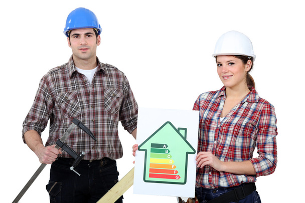 Construction workers holding an energy efficiency rating chart and a clamp - Photo, Image