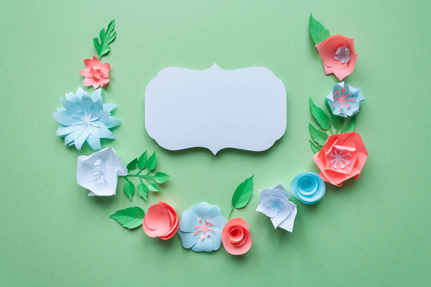 vintage frame with color paper flowers on the green background. Flat lay. Nature concept - Photo, Image