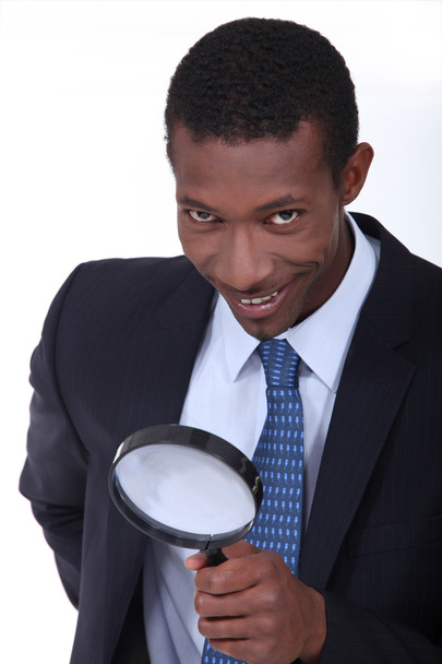 Businessman using magnifying glass - Valokuva, kuva