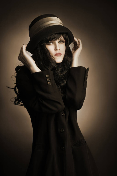 Brunette woman in black hat and dress portrait - Фото, зображення