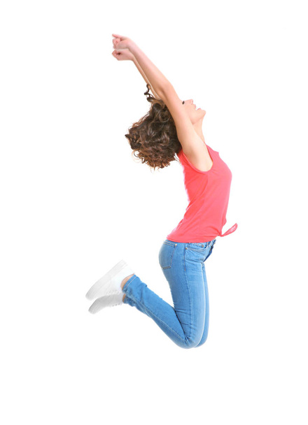 Joyful young woman jumping   - Foto, Bild