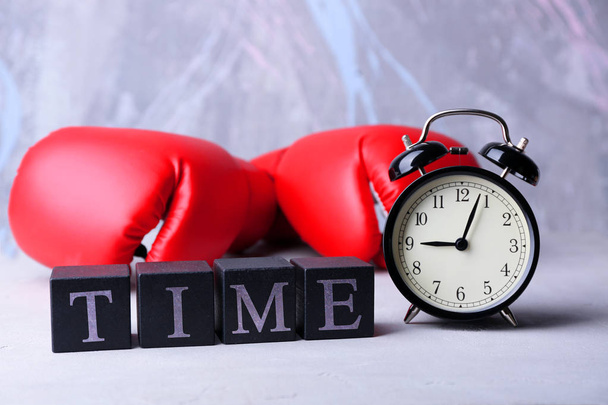 Cubes with alarm clock and boxing gloves  - Foto, Bild
