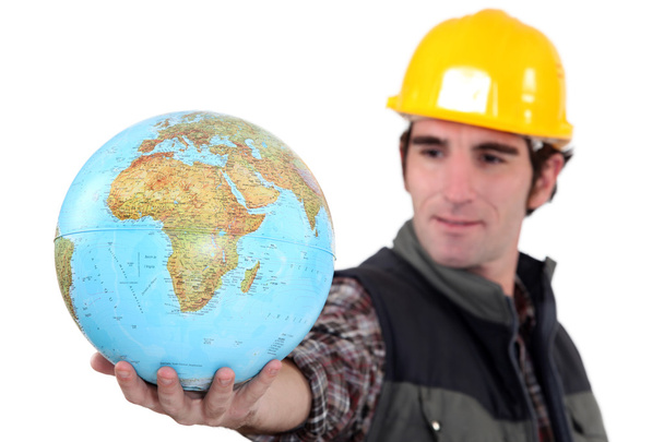 Tradesman holding a globe - Foto, afbeelding