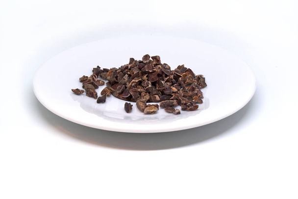 cacao nibs on a plate isolated - Photo, Image