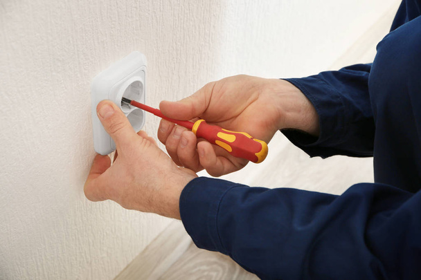 Electrician installing wall socket  - Φωτογραφία, εικόνα