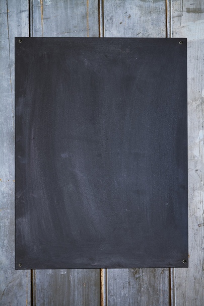 Vertical blackboard on an old fence background - Foto, immagini