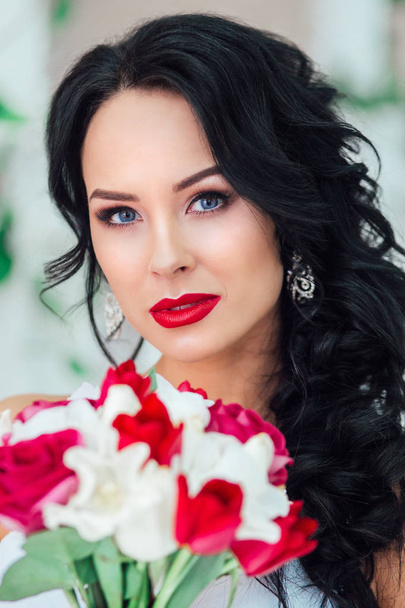 gorgeous bride with fashion makeup and hairstyle in a luxury wedding dress . Red lips - 写真・画像
