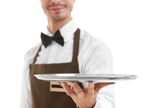Waiter holding empty silver tray over white background.Focus on the tray - Zdjęcie, obraz