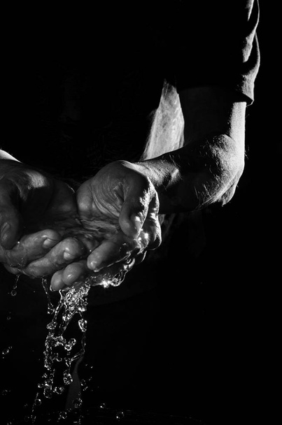 Water in male hands. - Foto, imagen