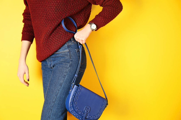 Young woman holding blue clutch - Фото, зображення